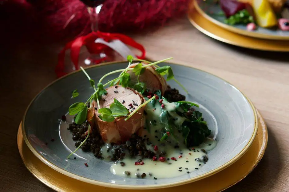 Delicious pork tenderloin with lentils, spinach, and creamy lemon sauce, perfect for a gourmet dinner.